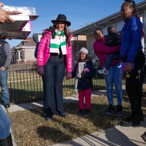(From left) Ald. Stephanie Coleman (16th), Sharnelle Martin, Aniyah Grant, and Gregory Martin react as tow trucks deliver toys in Englewood on Christmas Eve, Dec. 24, 2019.