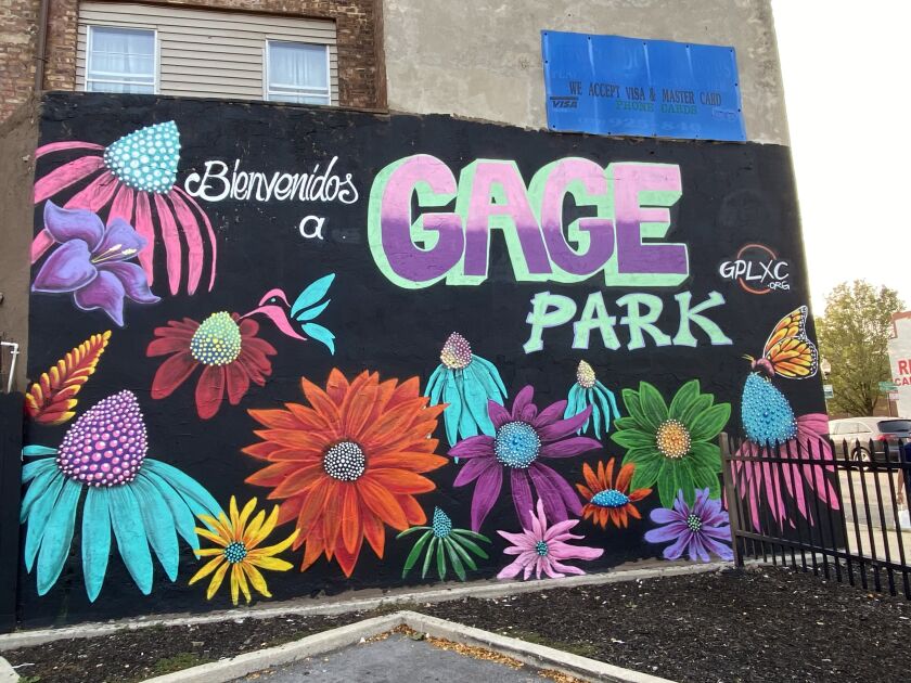 This mural by Mario Mena — head of the Gage Park Mural Project — includes flowers, a butterfly and the welcoming words “Bienvenidos a Gage Park.”