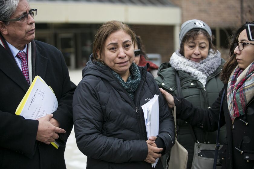 Luz Maria Garcia (center) speaks during a press conference outside the Skokie courthouse about the ICE arrest of her son, DACA recipient 29-year-old Christian Gomez Garcia, on Wednesday, Jan. 31, 2018. | Ashlee Rezin/Sun-Times
