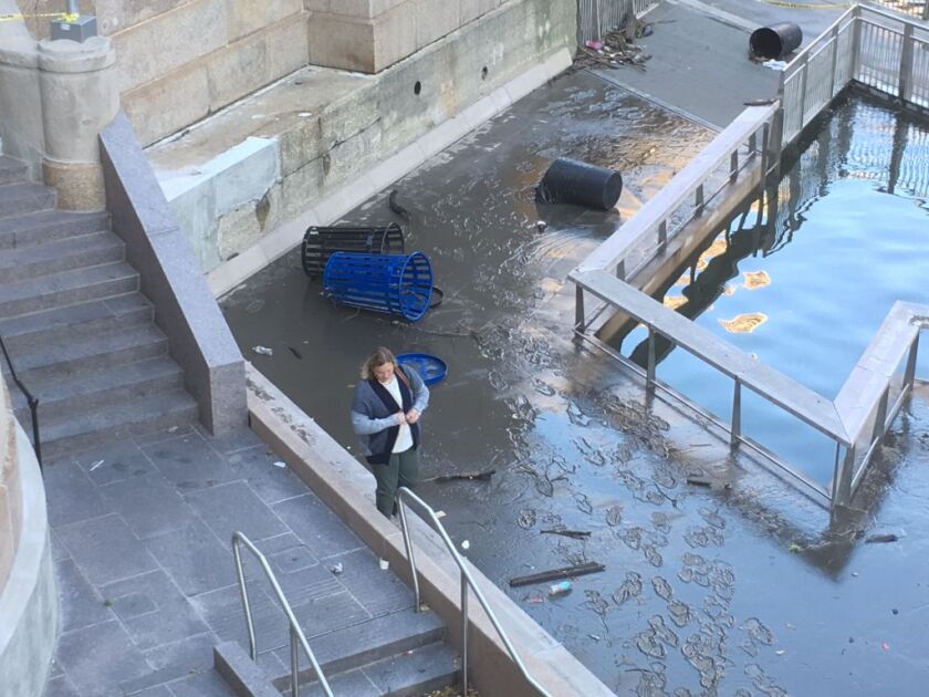 Though the Riverwalk was officially closed, that didn’t keep some people from using it as they dodged debris and the remaining high water. | Stefano Esposito/Sun-Times