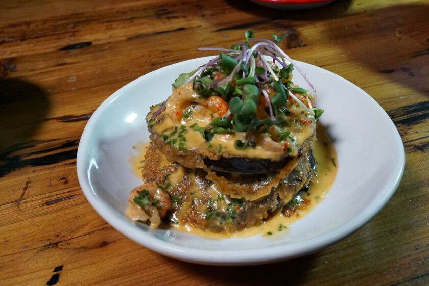 Eggplant Orleans, made at Ina Mae Tavern, is topped with crawfish beurre blanc, and fine herbs.