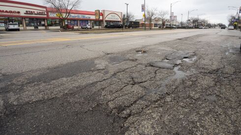 Potholes are seen along West Fullerton Avenue near North Mango Avenue in the Belmont Cragin neighborhood, where road work will start this spring.