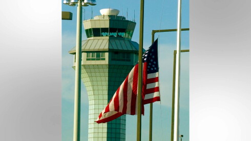 The American flag is shown at half mast at O'Hare Airport the day after the 9/11 attacks.