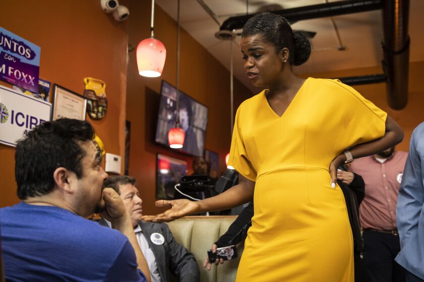 Cook County State’s Attorney Kim Foxx chats with a supporter during a campaign stop at Cecina Grill in Pilsen.