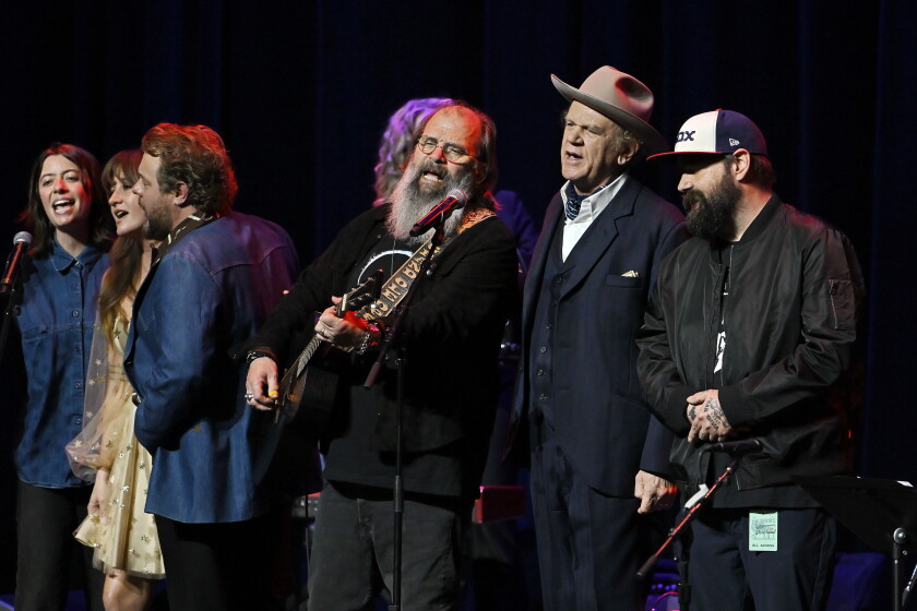 Margo Price, Nathaniel Rateliff, Steve Earle, John C. Reilly and other artists sing together during the final ensemble chorus of “Souvenirs: 80 Years of John Prine” at The Chicago Theatre on October 8, 2026.