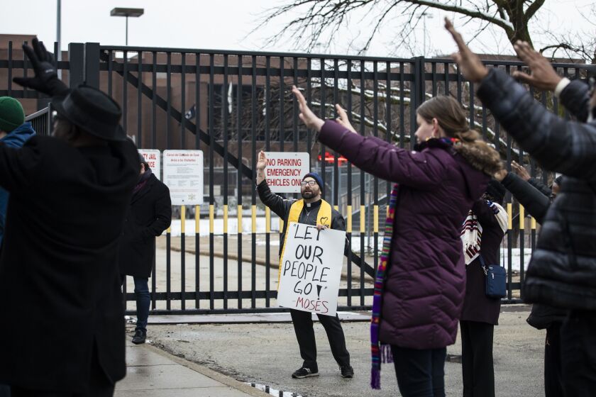 Rev. Jason Lydon, of the Second Unitarian Church of Chicago, leads a prayer with other faith leaders outside Cook County jail.