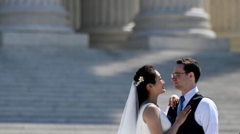 A couple takes their wedding pictures in front of the US Supreme Court in Washington, DC.