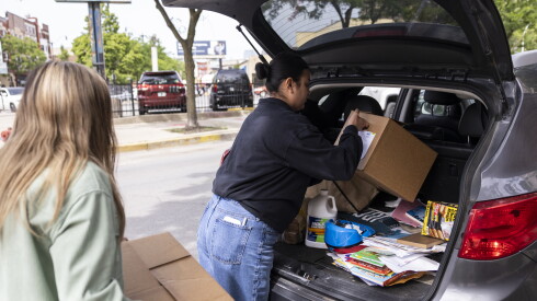 Workers load boxes of groceries into families’ vehicles at the Brightpoint El Hogar Del Niño food pantry, established through a partnership with Nourishing Hope, in Pilsen, Friday, May 22, 2026.