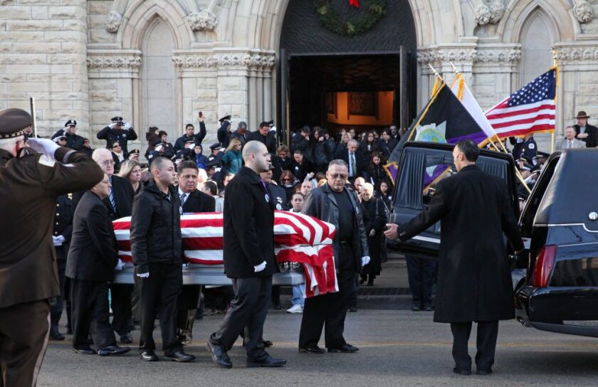 Family, friends and colleagues mourn outside Holy Name Cathedral after the funeral of slain Officer Cuauhtemoc Estrada on Saturday, December 28, 2013. | Chandler West/For Sun-Times Media
