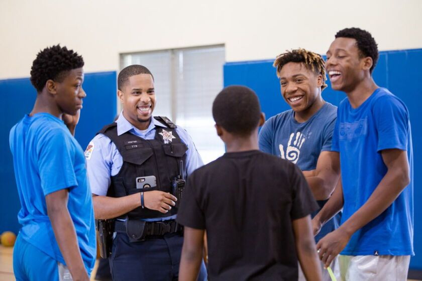 Police Officer Mister Jarrett talks with teens at the Union League Boys & Girls Club on Thursday, July 27, 2017. | Santiago Covarrubias/For the Sun-Times