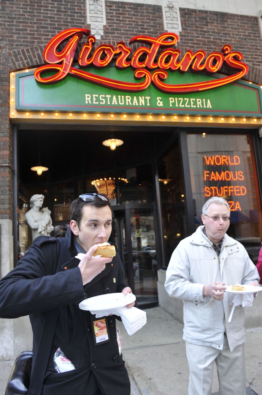Maebe A. Girl, left, the former George Pudlo, grew up in the Chicago area, where she ran “Second City Pizza Tours,” seen here back in 2010.