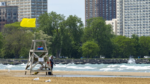 A pair of lifeguards stand by their lifeguard tower as waves roll into Montrose Beach, Friday, May 22, 2026. | Tyler Pasciak LaRiviere/Sun-Times