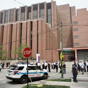 Police officers gather outside Advocate Illinois Masonic Medical Center after an officer was shot at the 25th District police station on the Northwest Side, Thursday, July 30, 2020.