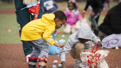 Kids collect plastic eggs during Harvest Worship Center Ministries’ “Easter Eggstravaganza” at Altgeld Park Hope Field in Garfield Park, Saturday, April 4, 2026. Dozens participated in the event, which featured bounce houses and a face painting booth.