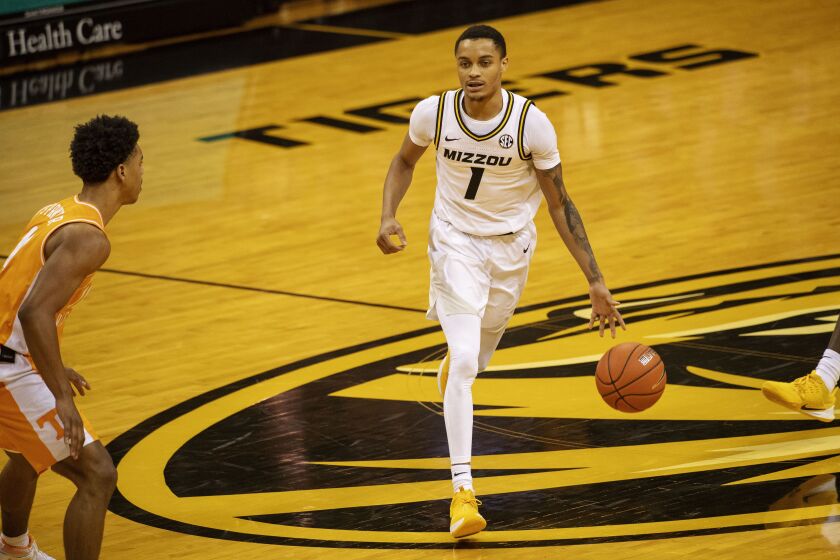 Missouri’s Xavier Pinson brings the ball up court during the second half of an NCAA college basketball game against Tennessee.
