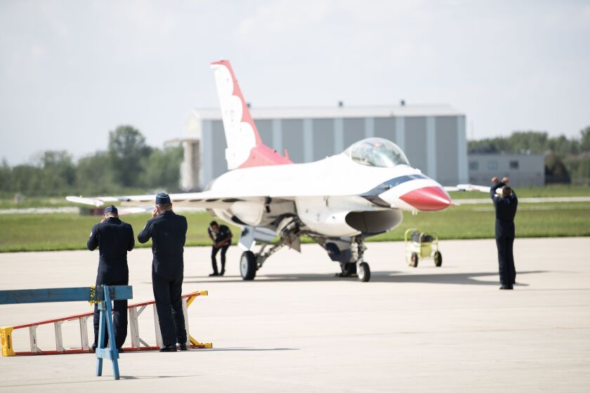 Thunderbird pilots cover their ears after an F-16 Flying Falcon lands Thursday at the Gary/Chicago International Airport in Gary.