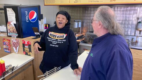 Elisha Evans speaks with customer Wayne Mahn