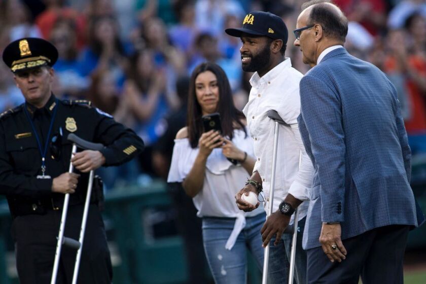 Former MLB player Joe Torre (right) walks with Capitol Police Special Agent David Bailey (second from right), who was wounded in Wednesday’s shooting, before the first pitch of the Congressional Baseball Game between Democrats and Republicans at Nationals