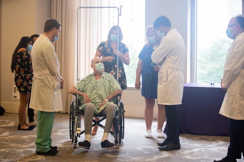 Brian Kuhns, 62, the second COVID-19 patient to receive a double-lung transplant at Northwestern Memorial Hospital, speaks to his doctors after a press conference at the hospital, Thursday morning, July 30, 2020.