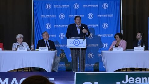 Gov. J.B. Pritzker speaks Saturday in front of New Hampshire Democrats.