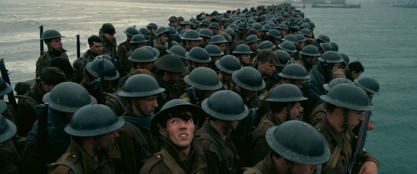 Allied troops await their fate in this scene from Christopher Nolan’s “Dunkirk.” | Warner Bros.