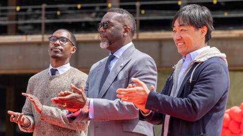 Mayor Brandon Johnson, Ald. Walter Redmond Burnett (27th), and Bally's chairman Soo Kim watch as the final structural beam is installed at the permanent Chicago casino location in River West.