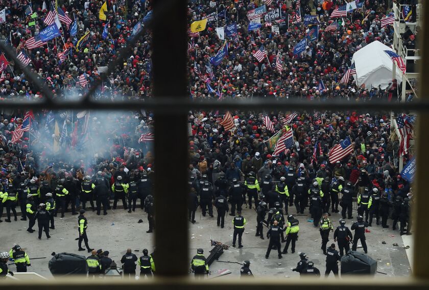 Police hold back supporters of President Donald Trump as they gather outside the Capitol on Jan. 6, 2021.