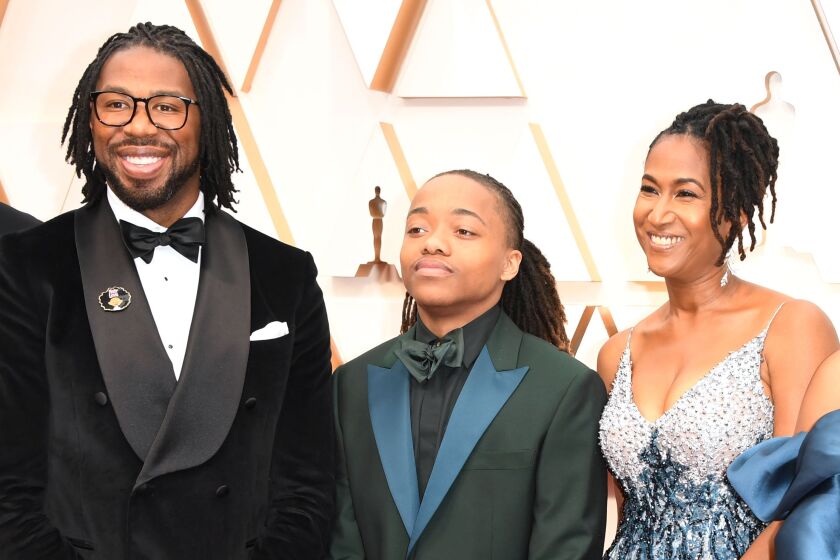 “Hair Love” director Matthew A. Cherry (from left), Texas high school student DeAndre Arnold and the film’s producer Karen Rupert Toliver arrive for the 92nd Oscars telecast on Sunday night.