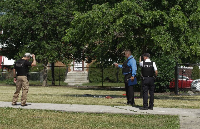 Police officers on the Warren School playground, where two girls were hit by gunfire. Their injuries are not believed to be life-threatening. | Leslie Adkins/For the Sun-Times