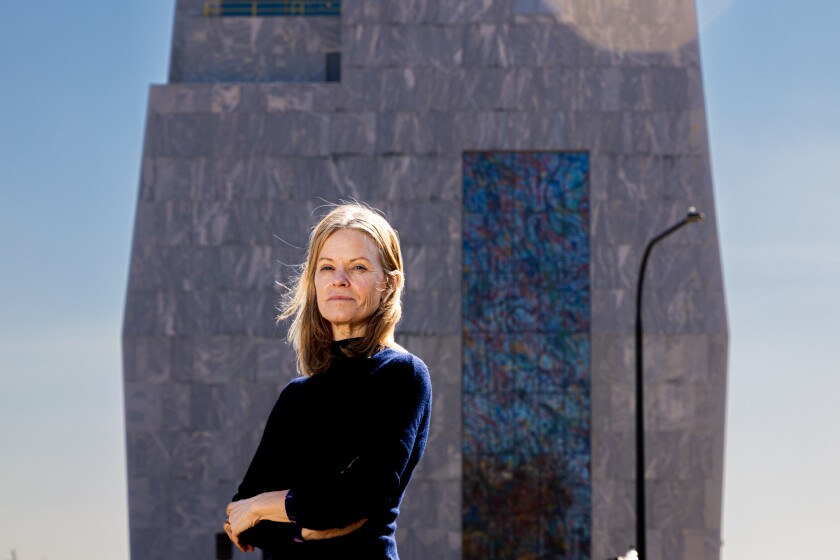 Virginia Shore, Curator of the Obama Presidential Center Art Commissions, stands in front of the museum tower in Jackson Park on the South Side, Thursday, March 12, 2026.