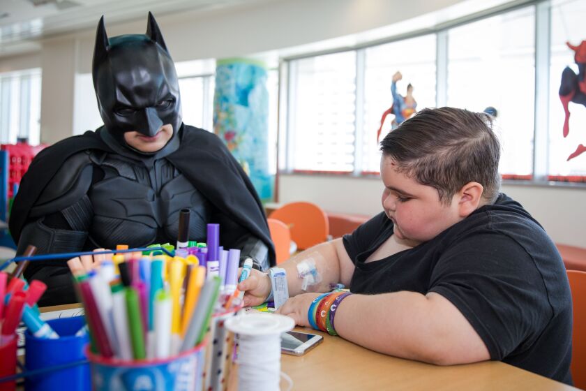 Tony Obando, 12, colors with Batman during Superhero Week at Ann & Robert H. Lurie Children’s Hospital of Chicago on Tuesday, June 27, 2017. | Santiago Covarrubias/For the Sun-Times