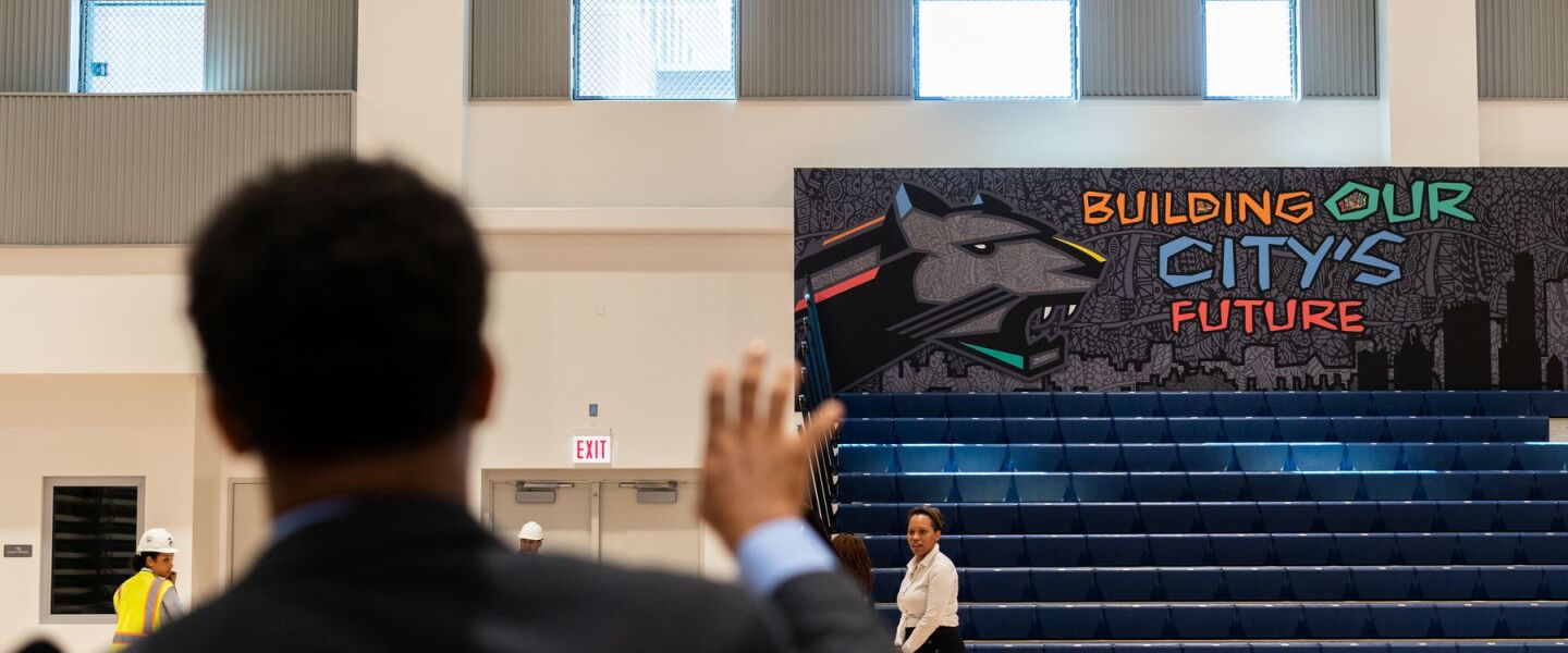 Conrad Timbers-Ausar, Englewood STEM High School’s principal, shows off a mural at the South Side school