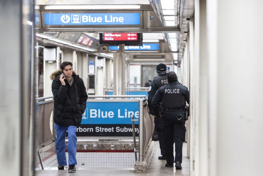 Chicago police officers patrol the Jackson Red Line platform on Friday.