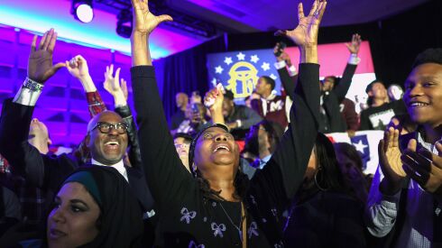 Supporters cheer as the George Senate runoff election is called for Democratic Sen. Raphael Warnock at the Warnock election right watch party at the Marriott Marquis in Atlanta, Georgia. 