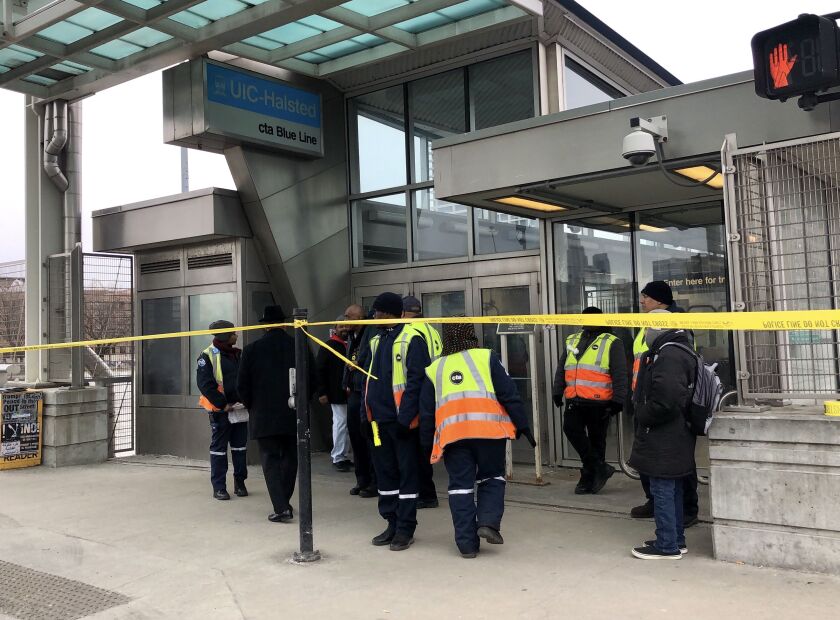 CTA personnel gather outside the Blue Line station at UIC-Halsted, 430 S. Halsted St.