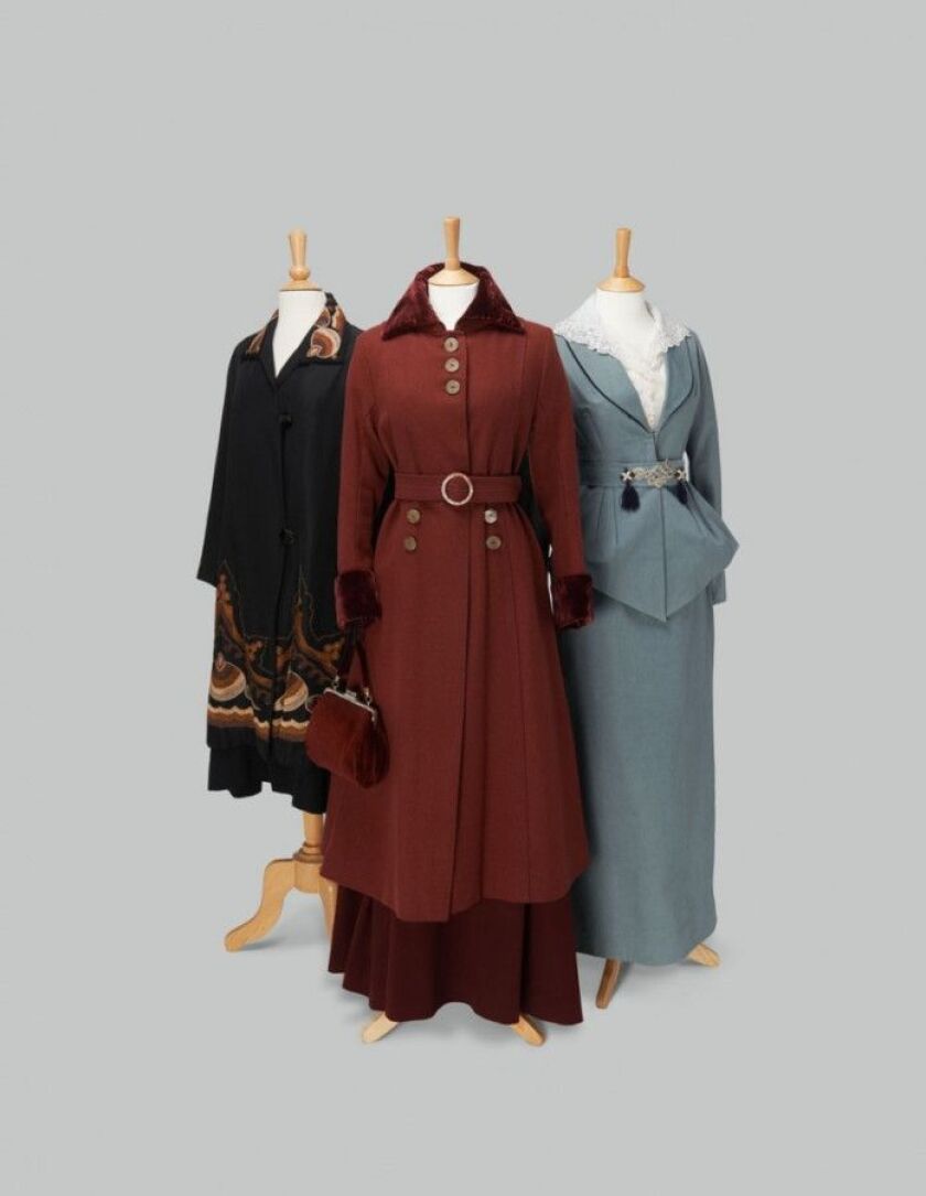 L to R: Black coat with English Arts and Crafts embroidery, burgundy coat, and blue/green suit and hat, worn by the Crawley sisters. | Costumes courtesy of Cosprop.