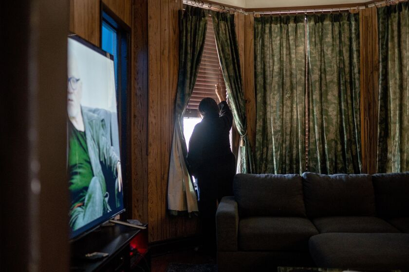 Margarita Gomez, 61, who said she witnessed police fatally shoot 13-year-old Adam Toledo from her window, closes a window in her living room in her home in the 2400 block of South Spaulding Ave. in the Little Village neighborhood, Saturday afternoon, April 3, 2021.