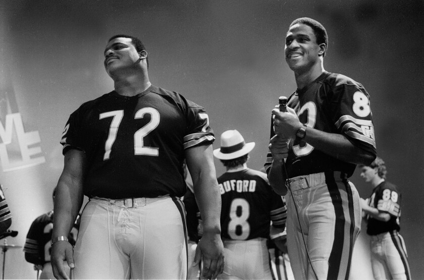 William Perry and Willie Gault stand on the set during filming of the Super Bowl Shuffle video.