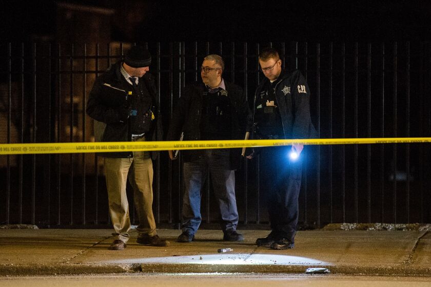 Chicago police investigate the scene where a 45-year-old man was found critically wounded in a shooting, Sunday night in the 9200 block of South Cottage Grove, in the Burnside neighborhood. | Tyler LaRiviere/Sun-Times