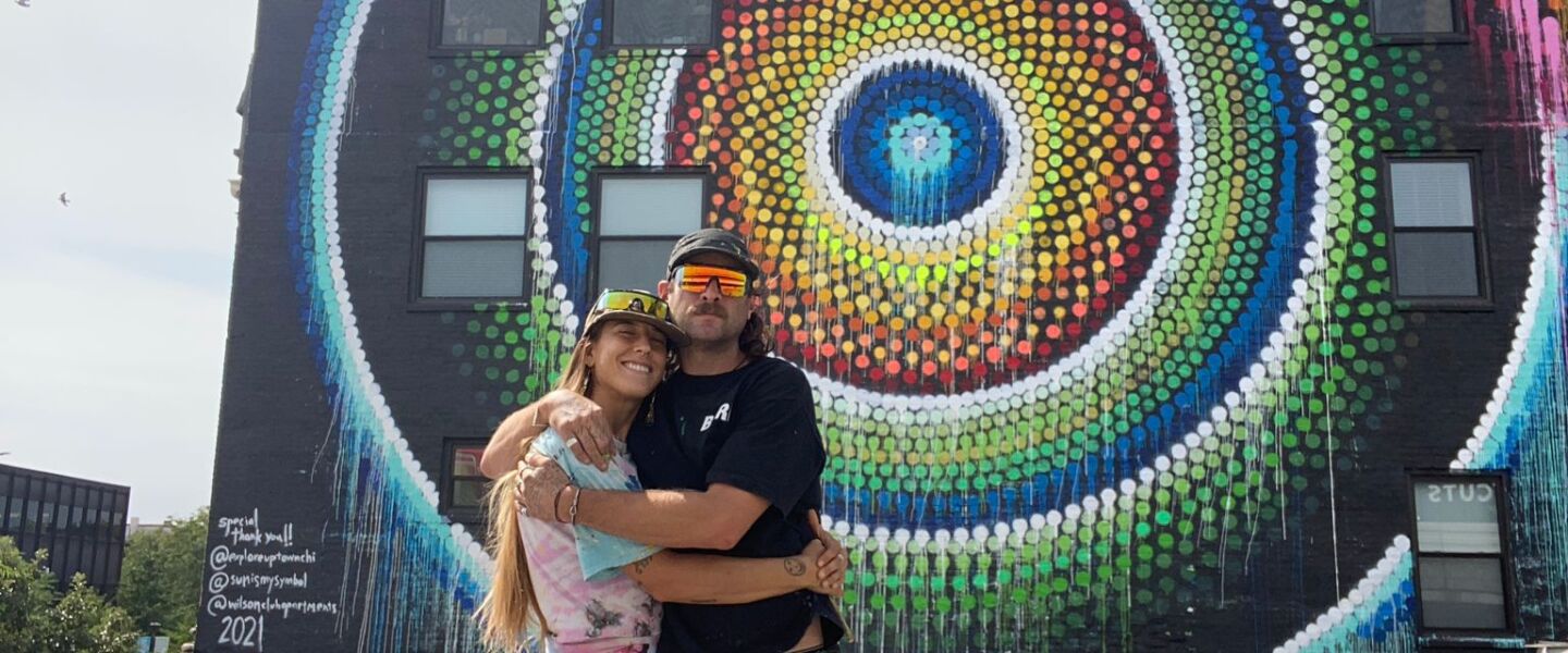 Artist Joe Miller and his girlfriend Sunni DiLuzio — who worked with him — in front of the “Uptown Dot King” mural at 1124 W. Wilson St.