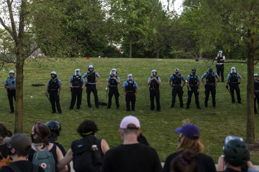 Chicago police and protesters face off in Grant Park after protesters attempted to topple a Christopher Columbus Statue located at Roosevelt and Columbus, Friday, July 17, 2020.