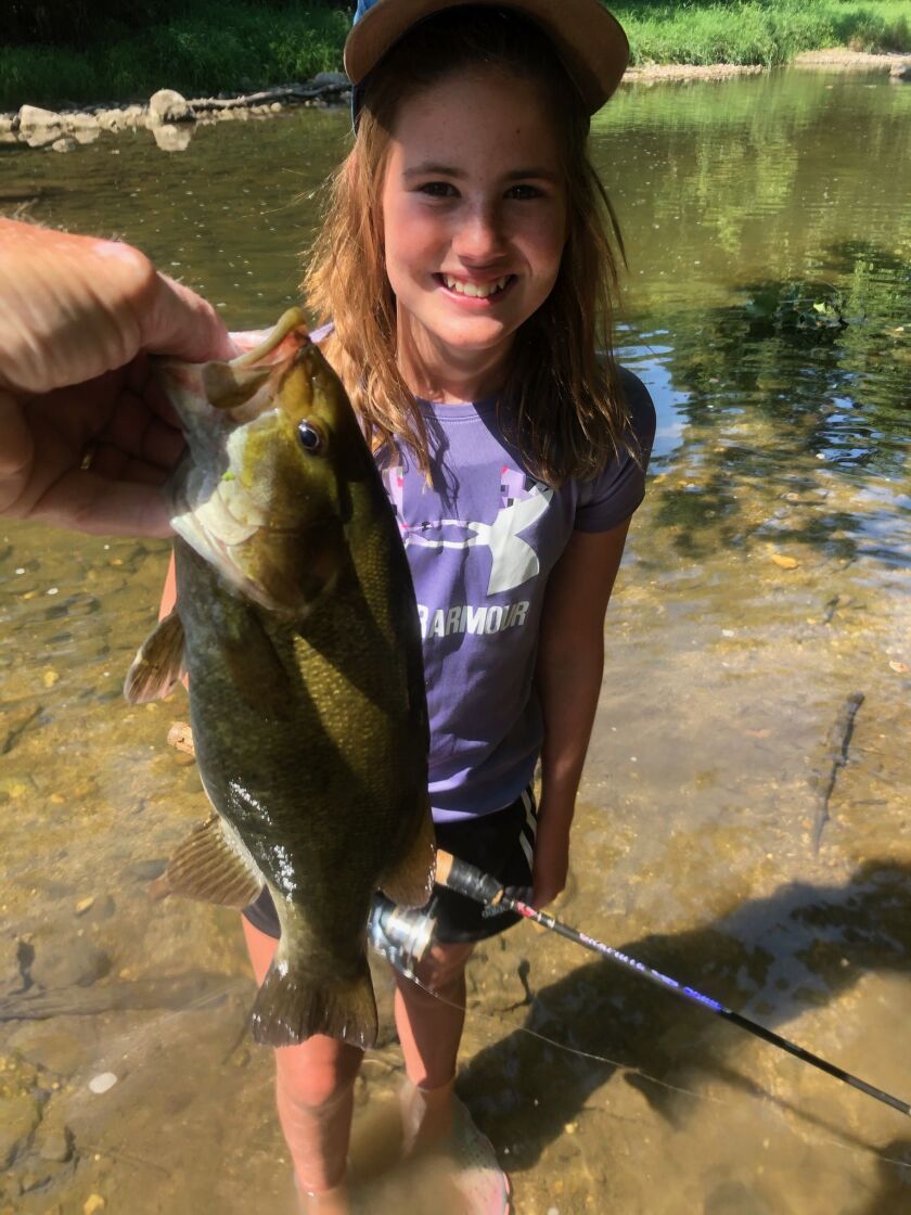 George Peters with a grandkid and a Kankakee River smallmouth bass. Provided photo