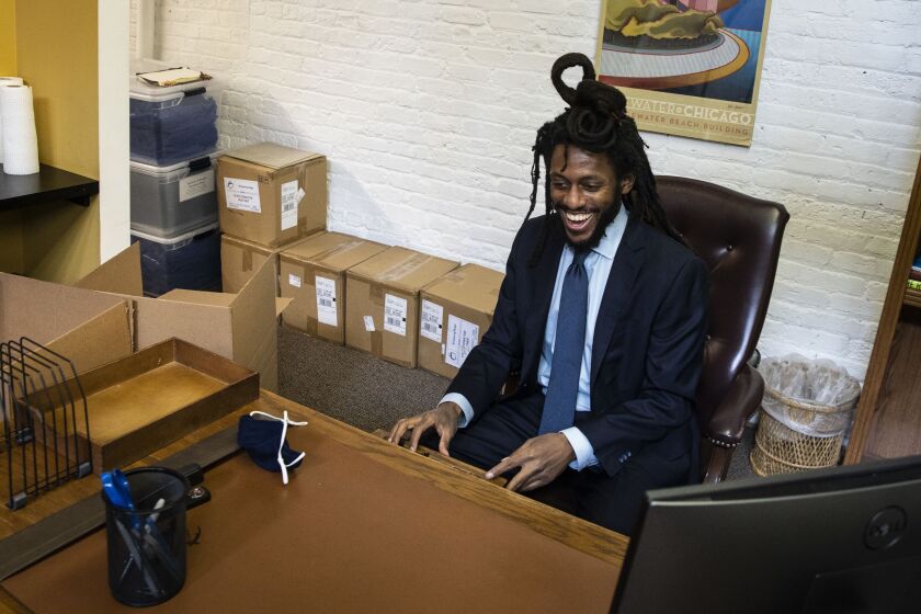 Newly appointed state Sen. Mike Simmons sits at his desk for the first time at his district office in the Edgewater neighborhood in February.