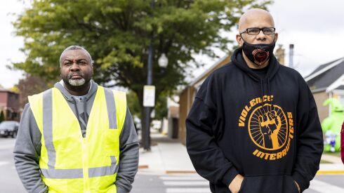 Napoleon English and Tio Hardiman stand at the site where a 3-year-old child was shot during a road rage incident on the corner of West Marquette Road and Kenneth Avenue in West Lawn, Sunday, October 2, 2022.
