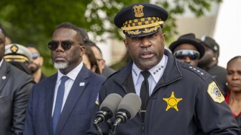 Mayor Brandon Johnson looks on as Chicago Police Supt. Larry Snelling speaks to reporters and community members during a summer safety press conference in May near Sherman Park in Back of the Yards.