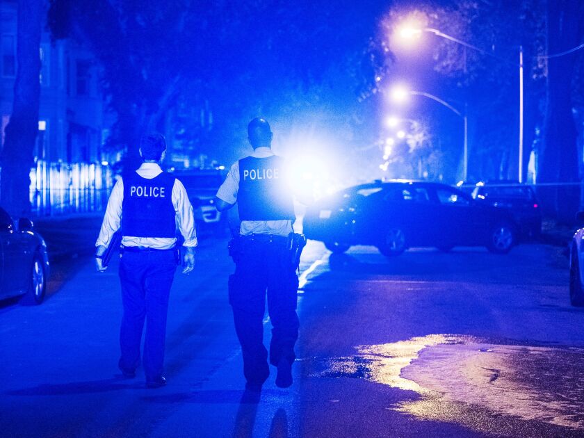 Police investigate a scene where multiple people were shot Sunday morning in the 6400 block of South Eberhart Ave. | Tyler LaRiviere/Sun-Times