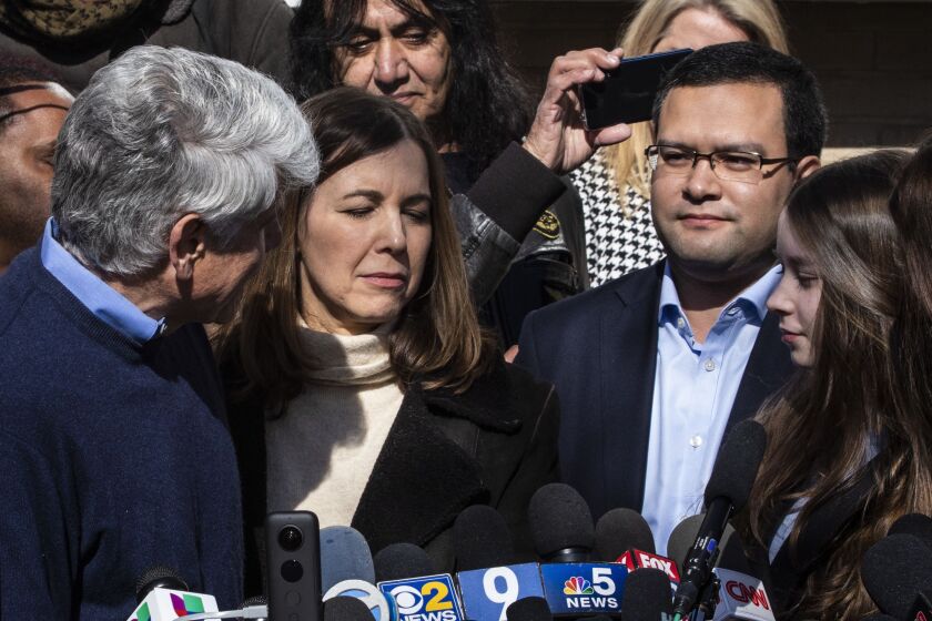 Former Illinois Gov. Rod Blagojevich thanks Mark Vargas, a political strategist and advisor, as he speaks to reporters outside the family’s Ravenswood Manor home in February.