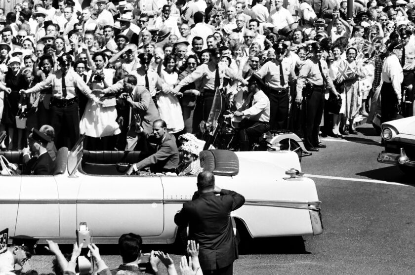 Crowds of people line the streets of Michigan Avenue, State Street and Oak Street to see the procession of Queen Elizabeth II