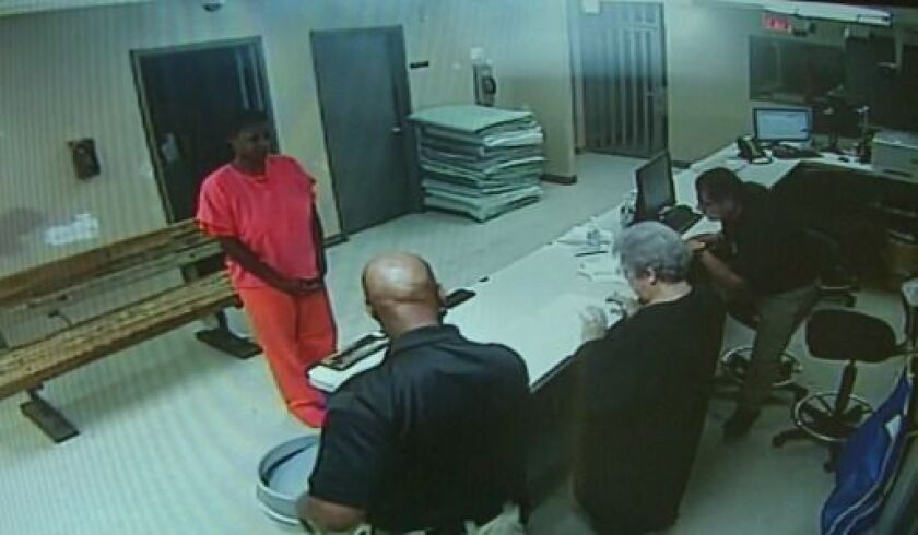 In an image from a video provided by the Waller County, Texas, Sheriff’s Department, Sandra Bland stands in front of a desk at the Waller County Jail in Hempstead, Texas. Waller County Sheriff’s Department via AP