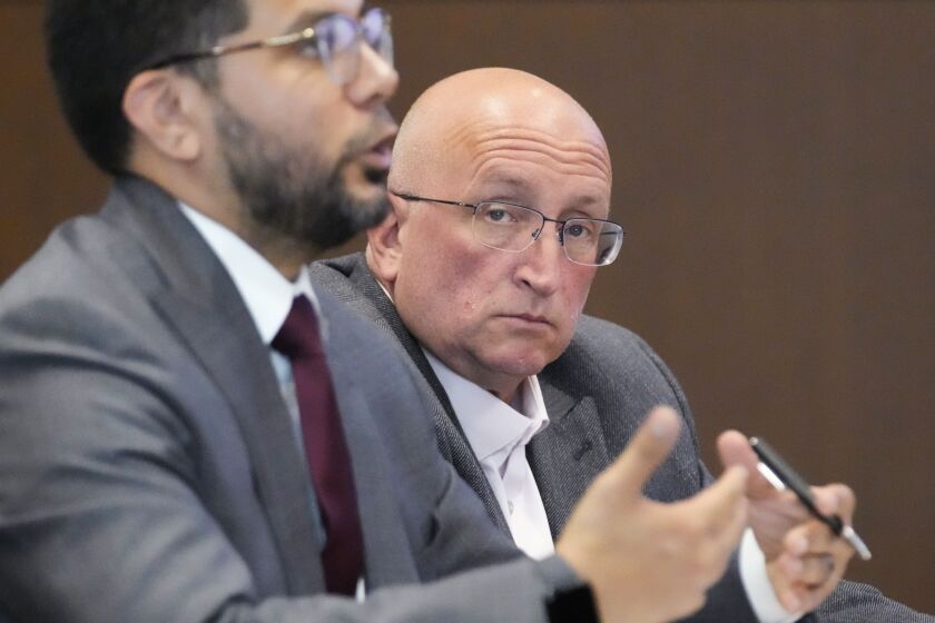 Attorney George Gomez, left, speaks to Judge George D. Strickland as Robert E. Crimo Jr., looks on during an appearance at the Lake County Courthouse, Monday, Aug. 7, 2023, in Waukegan, Ill.